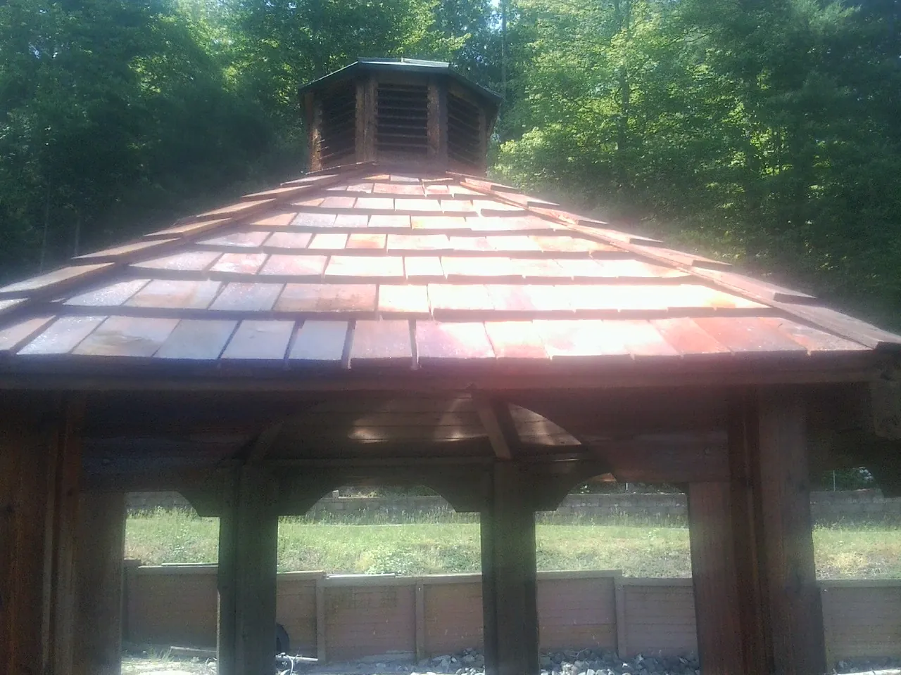 New cedar shake roof and cupola on a lakeside gazebo in Leola
