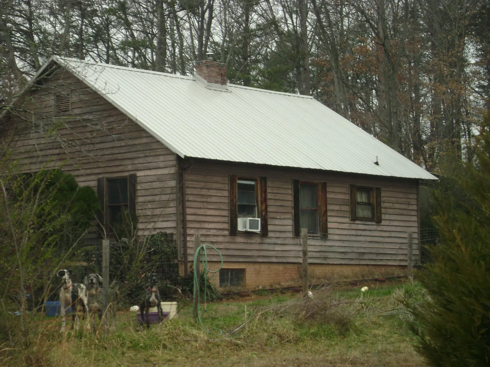White metal roof on an old wood sided farmhouse, from a Metal Roof Installation job in Leola